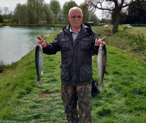 brian holding two fly caught rainbow trout