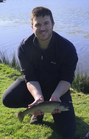Callum with his first rainbow trout on his first fly fishing lesson